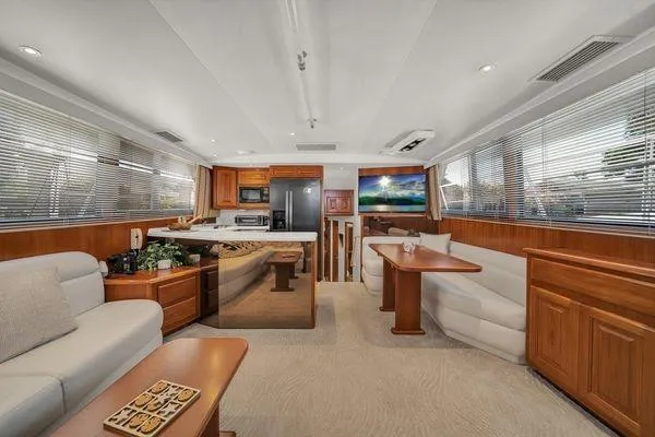 Slide: The Image of Luxurious interior of a 1993 Viking Convertible yacht with modern kitchen and seating area. - 27