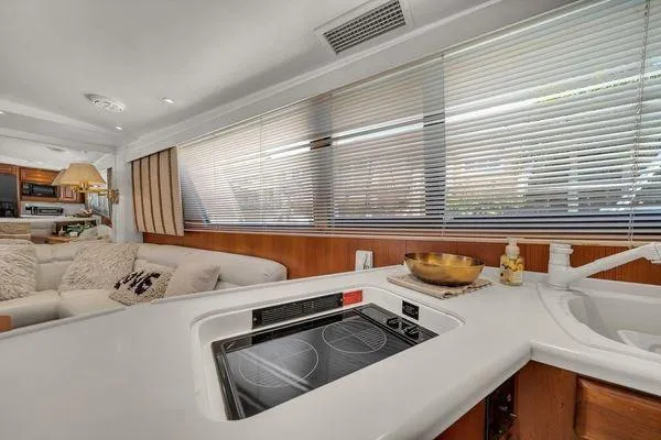 Slide: The Image of Interior of a 1993 Viking Convertible yacht with modern kitchen and cozy seating area. - 28