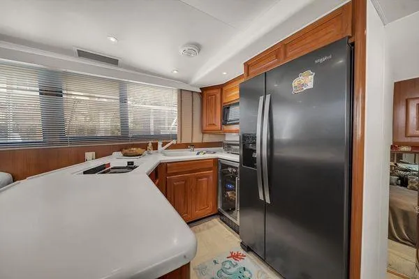 Slide: The Image of Luxurious kitchen interior in a 1993 Viking Convertible yacht with modern appliances. - 29