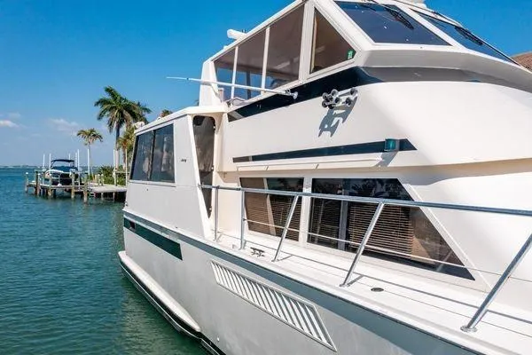 Slide: The Image of 1993 Viking Convertible yacht docked by tropical waters with palm trees in the background. - 3