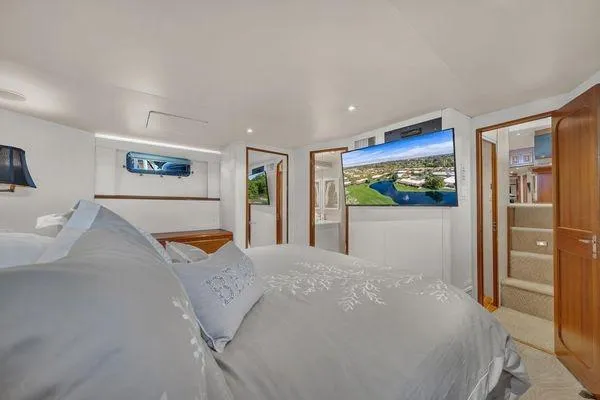 Slide: The Image of Luxurious bedroom interior of a 1993 Viking Convertible yacht with modern amenities. - 31