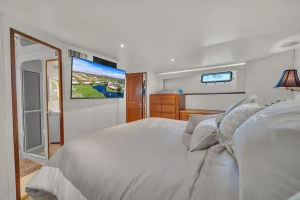 Slide: The Image of Luxurious bedroom interior of a 1993 Viking Convertible yacht with modern amenities. - 32
