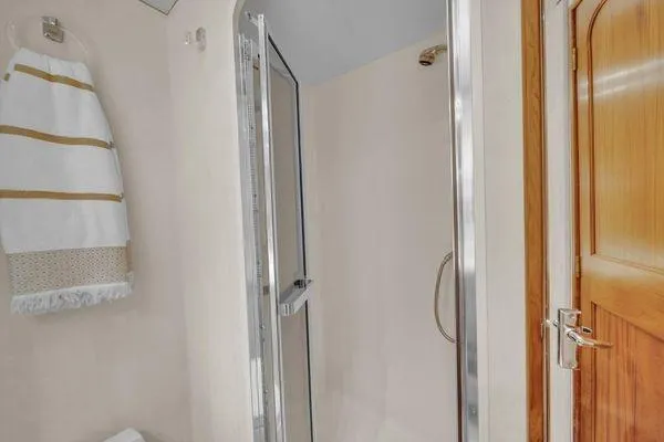 Slide: The Image of Bathroom interior of a 1993 Viking Convertible yacht with shower and towel rack. - 34