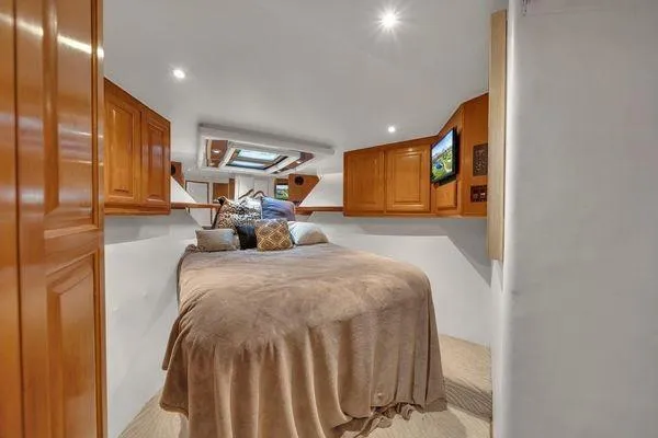 Slide: The Image of Luxurious 1993 Viking Convertible cabin interior with cozy bed and wooden cabinetry. - 35