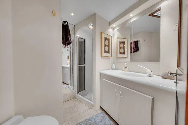 Slide: The Image of Luxurious bathroom in a 1993 Viking Convertible yacht, featuring modern fixtures and elegant decor. - 37