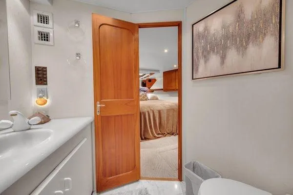 Slide: The Image of Bathroom interior of a 1993 Viking Convertible yacht with wooden door and modern decor. - 39