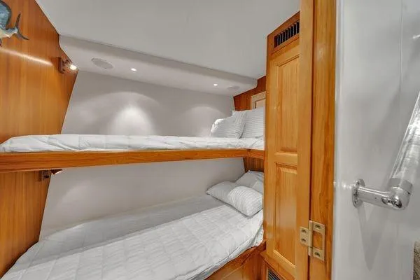 Slide: The Image of Bunk beds in a 1993 Viking Convertible yacht cabin with wooden accents. - 41