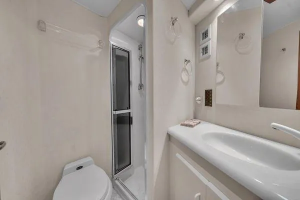 Slide: The Image of Bathroom interior of a 1993 Viking Convertible yacht with shower and sink. - 42