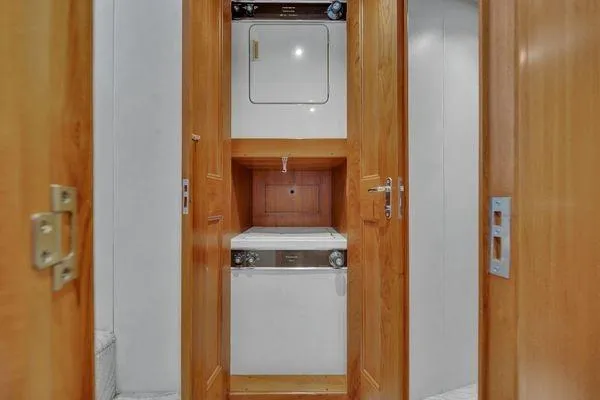 Slide: The Image of Laundry area inside 1993 Viking Convertible yacht with wooden cabinetry. - 43