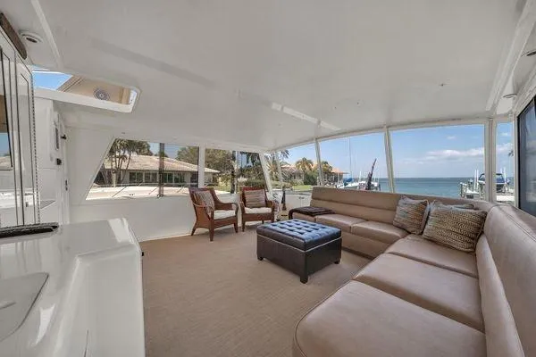 Slide: The Image of Spacious interior of a 1993 Viking Convertible yacht with comfortable seating and ocean view. - 44