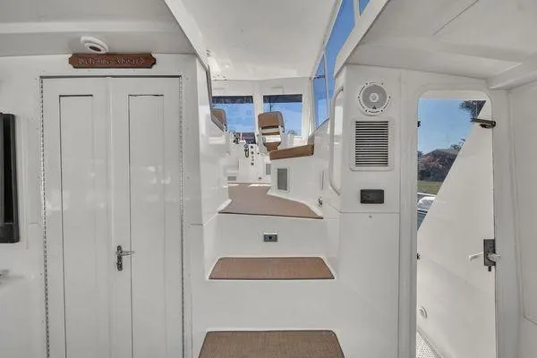 Slide: The Image of Interior view of a 1993 Viking Convertible yacht, featuring white steps and seating. - 47