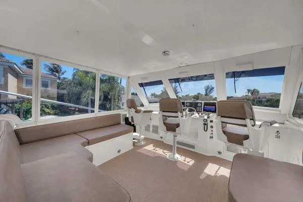 Slide: The Image of Interior of a 1993 Viking Convertible yacht with modern seating and navigation controls. - 48