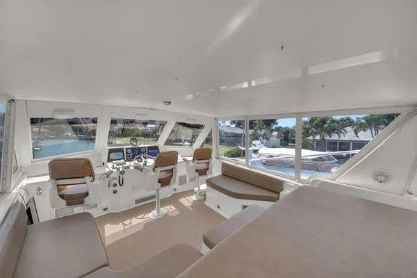 Slide: The Image of Interior of a 1993 Viking Convertible yacht with spacious seating and helm. - 49