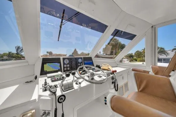 Slide: The Image of 1993 Viking Convertible yacht helm with navigation equipment and leather seating. - 50