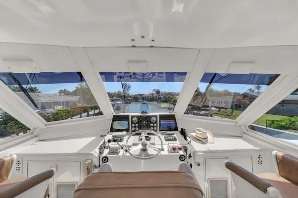 Slide: The Image of 1993 Viking Convertible yacht helm with panoramic windows and navigational controls. - 51
