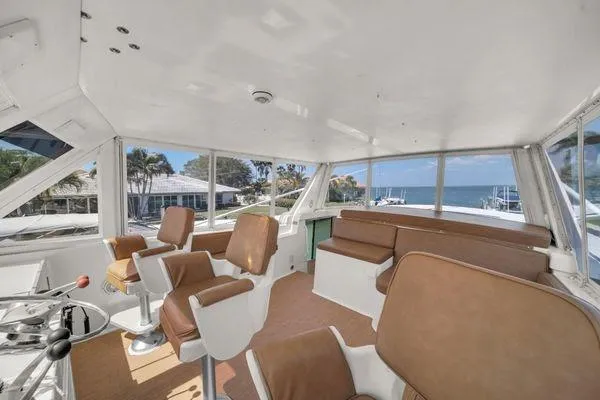 Slide: The Image of Interior of a 1993 Viking Convertible yacht with brown seating and ocean view. - 52