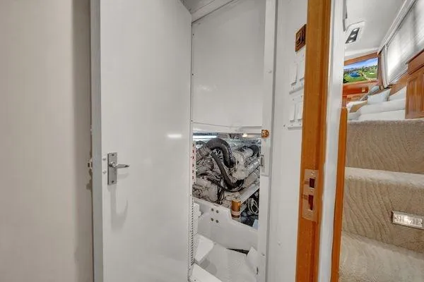 Slide: The Image of 1993 Viking Convertible yacht engine room with open door and visible staircase. - 53