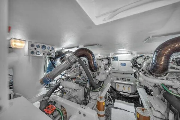 Slide: The Image of Engine room of a 1993 Viking Convertible yacht, showcasing machinery and equipment. - 54