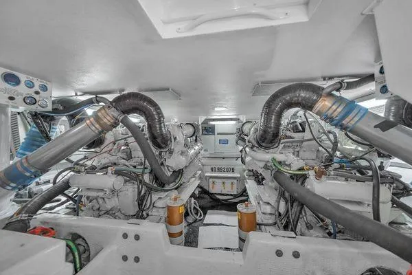 Slide: The Image of Engine room of a 1993 Viking Convertible boat, showcasing dual engines and mechanical components. - 57