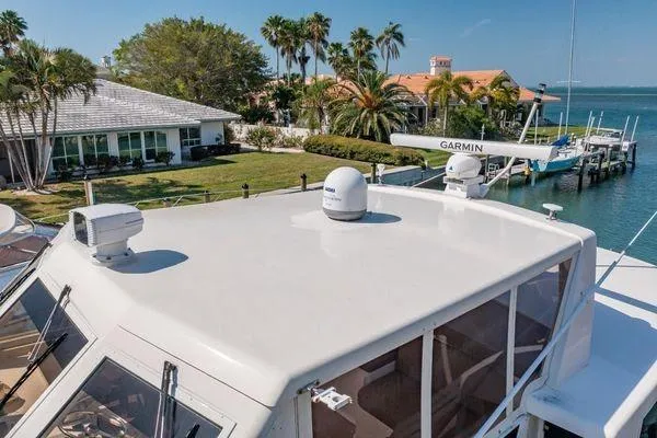 Slide: The Image of 1993 Viking Convertible yacht with Garmin radar, docked near waterfront homes and palm trees. - 8