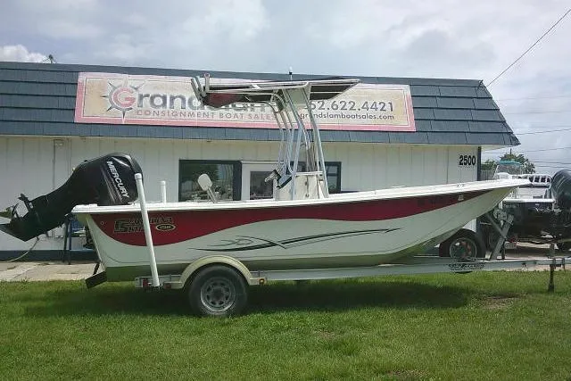 Slide: The Image of 2013 Carolina Skiff 198 DLV boat on trailer, parked outside dealership. - 1