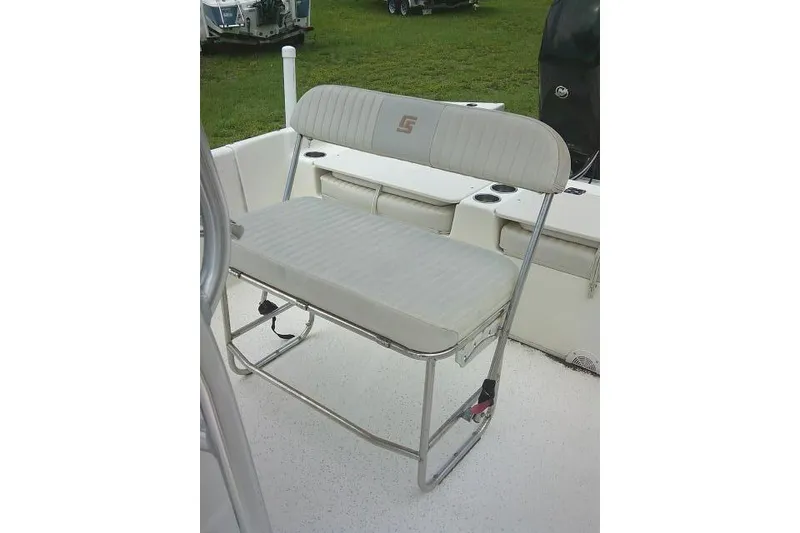 Slide: The Image of 2013 Carolina Skiff 198 DLV boat seat with white upholstery and metal frame. - 11