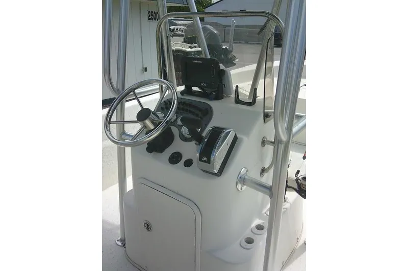 Slide: The Image of Console of a 2013 Carolina Skiff 198 DLV boat with steering wheel and controls. - 12