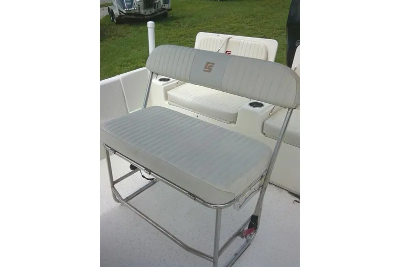 Slide: The Image of 2013 Carolina Skiff 198 DLV boat seat with white upholstery and metal frame. - 15