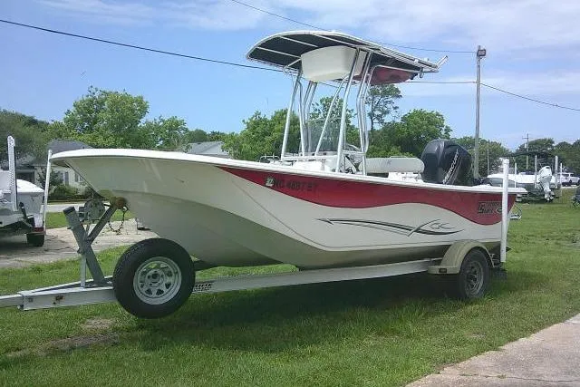 Slide: The Image of 2013 Carolina Skiff 198 DLV boat on trailer, parked outdoors. - 3