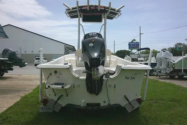 Slide: The Image of 2013 Carolina Skiff 198 DLV boat with outboard motor, parked on grass. - 5