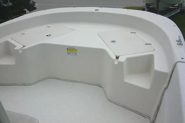 Slide: The Image of 2013 Carolina Skiff 198 DLV boat interior, featuring spacious seating and storage compartments. - 8