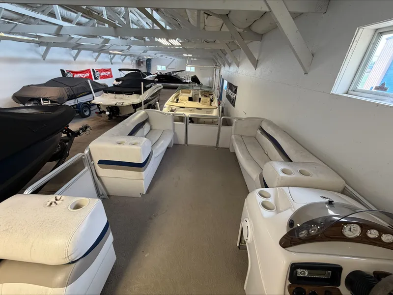 Slide: The Image of Interior view of a 2007 Harris Sunliner 180 with white seating and a helm console. - 17