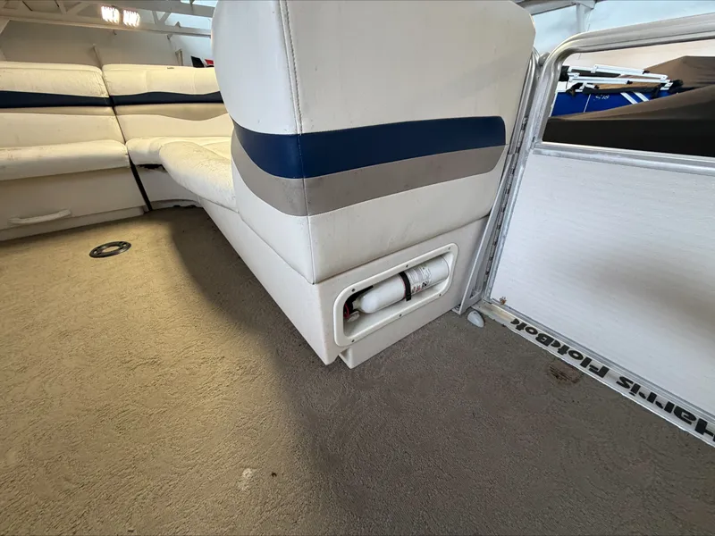 Slide: The Image of Interior of a 2007 Harris Sunliner 180 with white and blue upholstery. - 7