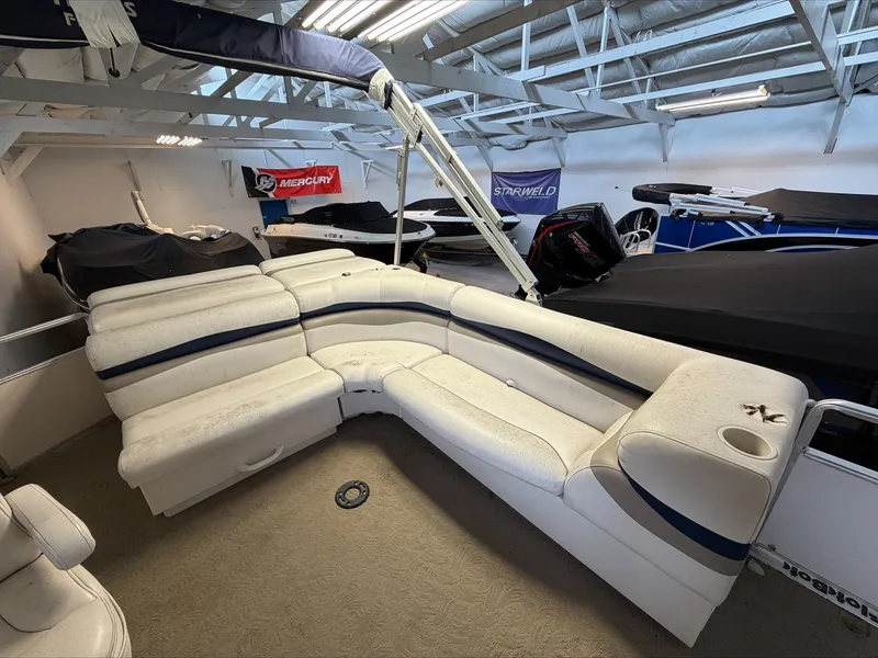 Slide: The Image of The image shows the interior of a 2007 Harris Sunliner 180 with white upholstered seating. - 5
