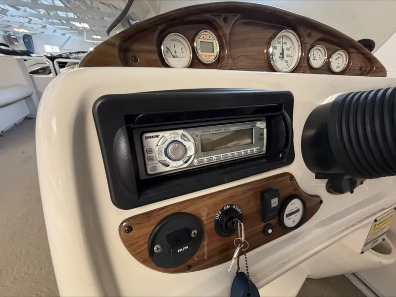 Slide: The Image of The image shows the dashboard of a 2007 Harris Sunliner 180 with a radio and various gauges. - 11