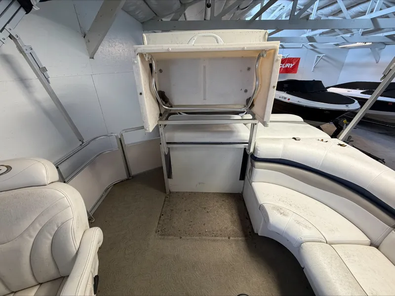Slide: The Image of The image shows the interior of a 2007 Harris Sunliner 180 with white seating and a table. - 6