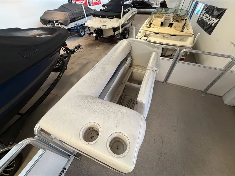 Slide: The Image of A 2007 Harris Sunliner 180 in a storage facility, surrounded by other boats. - 21