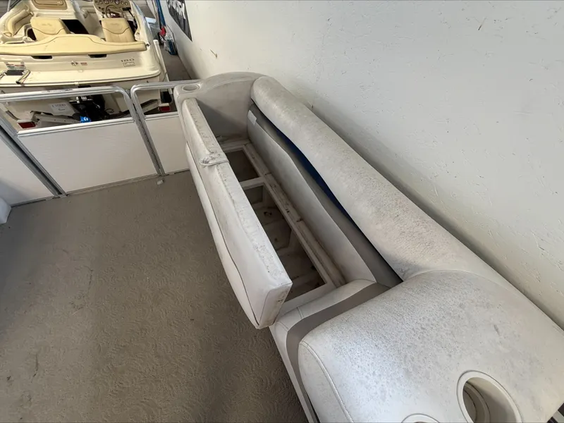 Slide: The Image of A white boat seat cushion with storage underneath, placed indoors. - 19