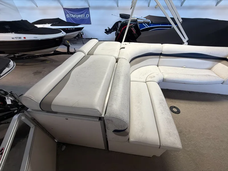 Slide: The Image of The image shows the interior of a 2007 Harris Sunliner 180 with white upholstered seating. - 3