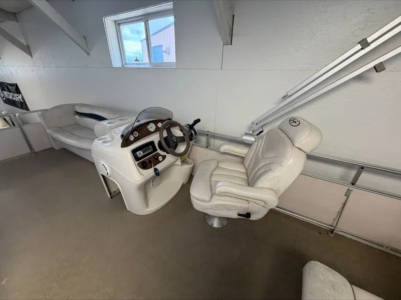Slide: The Image of Interior of a 2007 Harris Sunliner 180 with white helm and seating. - 9