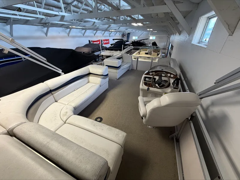 Slide: The Image of Interior view of a 2007 Harris Sunliner 180 with white seating and a helm station. - 4