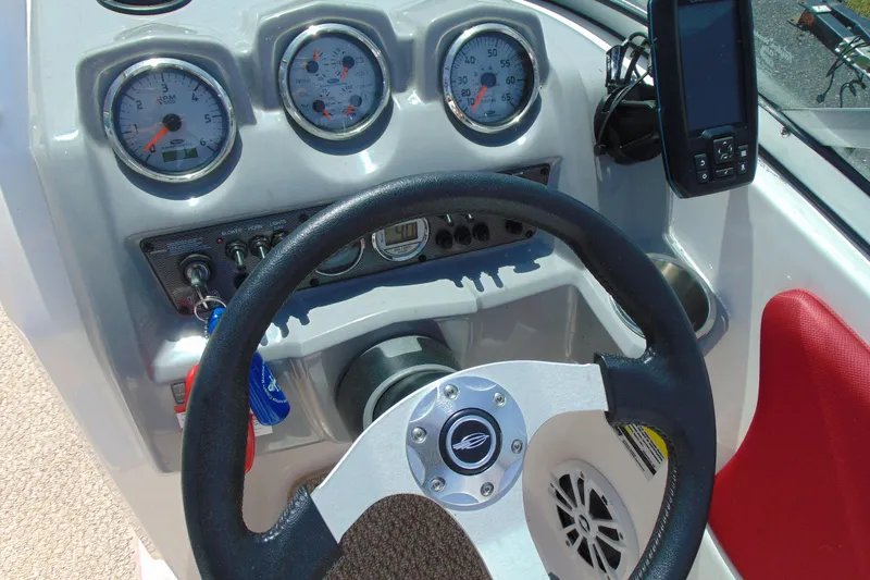 Slide: The Image of Dashboard of a 2013 Chaparral 19 Sport H2O boat with steering wheel and gauges. - 11