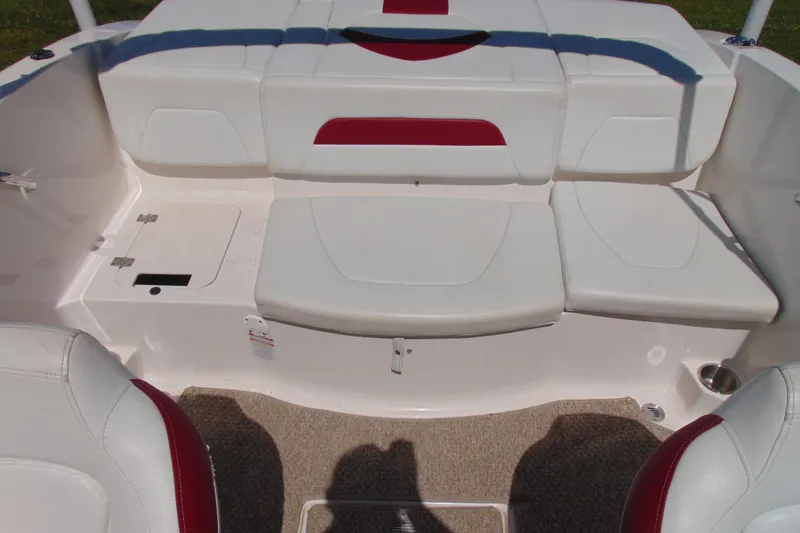 Slide: The Image of 2013 Chaparral 19 Sport H2O boat interior with white and red seating. - 8