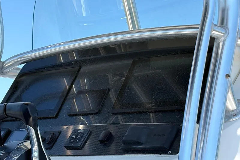 Slide: The Image of 2008 Edgewater 268CC boat dashboard with navigation screens and controls. - 5