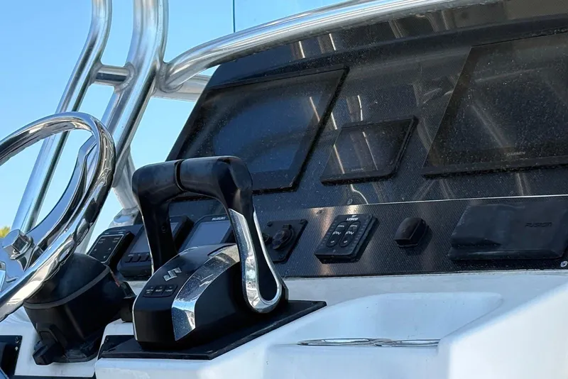 Slide: The Image of Control panel of a 2008 Edgewater 268CC boat with steering wheel and electronic displays. - 6