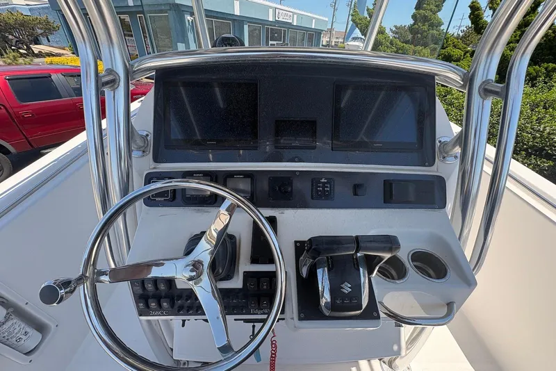 Slide: The Image of 2008 Edgewater 268CC boat dashboard with steering wheel and control panel. - 7