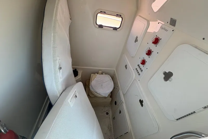 Slide: The Image of Interior of 2008 Edgewater 268CC boat showing control panel and storage compartments. - 8