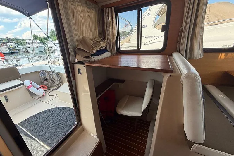 Slide: The Image of Interior view of 2016 Ranger Tugs R-27 boat with seating and window. - 13