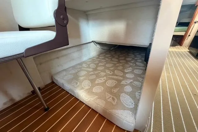 Slide: The Image of 2016 Ranger Tugs R-27 interior cabin with patterned mattress and wooden flooring. - 15