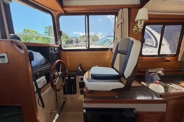 Slide: The Image of Interior of 2016 Ranger Tugs R-27 boat with helm and seating area. - 26